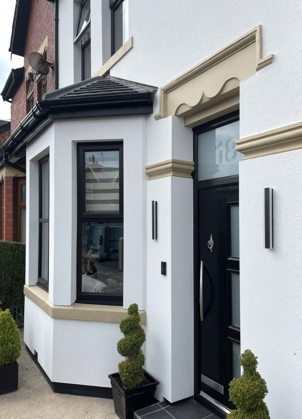 White rendered entrance and bay with a cream door surround